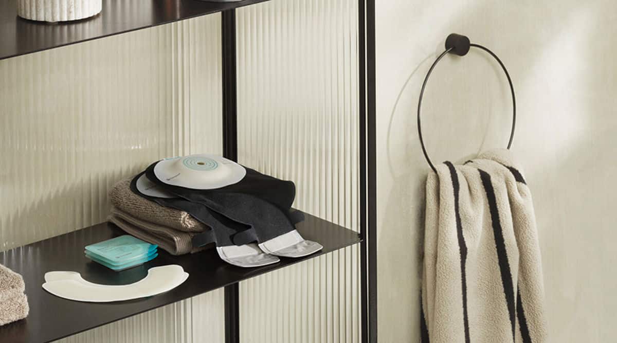 Coloplast ostomy products neatly arranged on a bathroom shelf